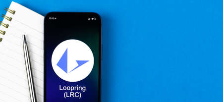 Loopring LRC symbol. Trade with cryptocurrency, digital and virtual money, banking with mobile phone concept. Business workspace, banner, table top viewの写真素材
