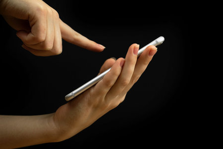 Mobile phone and index finger isolated, palm up, product demonstration concept. Copy space, templateの写真素材