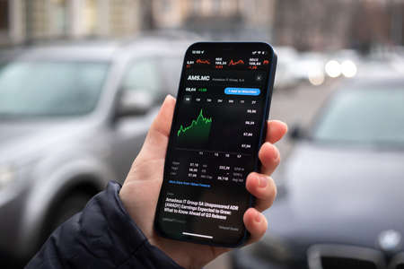 Kharkov, Ukraine - December 1, 2021: Amadeus AMS MC stock trade. Financial graphs, investment, digital banking concept photo. Smartphone with stock market app in handのeditorial素材