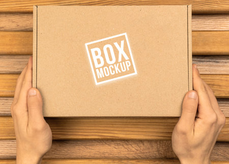 Cardboard box mockup, top view photo. Packaging and stre product concept. Wooden table background....