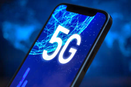 Smartphone with 5G network connection. Future of high speed mobile internet, global wireless technology backgroundの写真素材