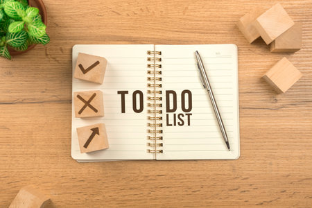 To do list concept. Wooden table background with empty notebook. Planning for new year, goal list, strategy. Top viewの写真素材