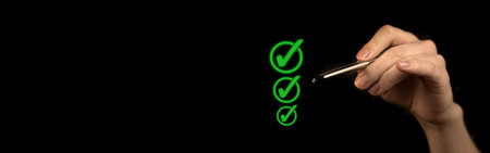 Hand marking checklist, to do and planning concept. Black background, green approved mark, business banner photoの写真素材