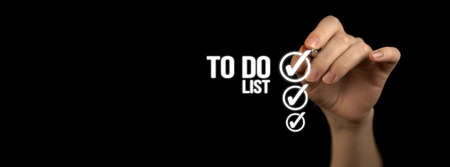 To do list with checklist boxes. Hand marking with pen on a black background, bannerの写真素材