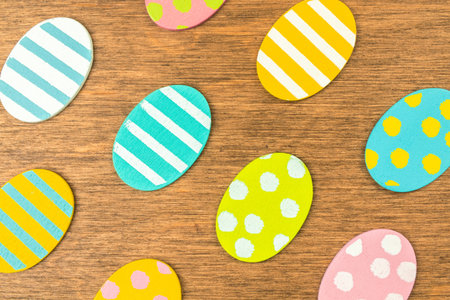 Happy easter eggs on an old rustic wood background. Flat lay design, top view with copy space