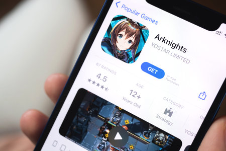 Kharkov, Ukraine - January 19, 2022: Arknights game app. Girl holding mobile phone with game and...