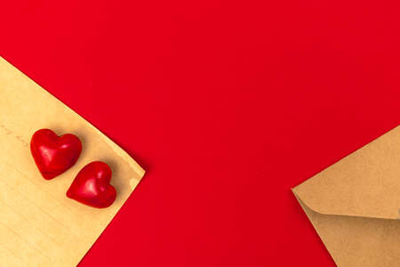 Vintage love letters with two red hearts. Valentines Day, 14th February concept, bright red background, Flat lay, top view and copy spaceの写真素材