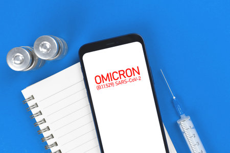 Coronavirus Omicron B.1.1.529 mutations. Medical table background with syringe and vaccine vials,...