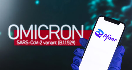 Kharkov, Ukraine - January 27, 2022: Phizer on background omicron text, COVID-19 new vaccine from...