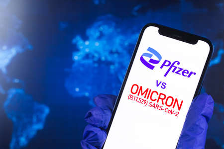 Kharkov, Ukraine - January 27, 2022: Phizer vs Omicron variant of coronavirus, world map background. Vaccination concept photoのeditorial素材