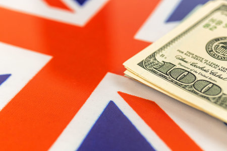 Money over the United Kingdom flag. Criminal, crime and corruption concept. UK outlaw and social...