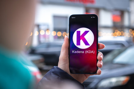 Kharkov, Ukraine - February 2, 2022: Kadena KDA coin symbol. Trade with cryptocurrency, digital and virtual money, mobile banking. Hand with smartphone, screen with crypto icon close-upのeditorial素材