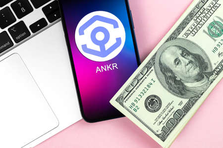 ANKR coin symbol. Trade with cryptocurrency, digital and virtual money, banking with mobile phone concept. Business workspace, table with laptop top view photoのeditorial素材