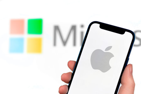 Apple vs microsoft concept. Mobile phone with on the screen, close-up view, business