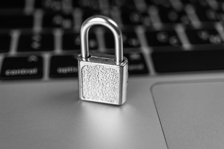 Computer security concept. Padlock on computer keyboard, laptop in office. Cyber security and...