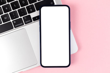 Flat lay smartphone mockup, office desktop with laptop, bright pink background. top view, copy space