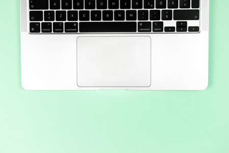 Modern laptop keyboard flat lay bright background. Office workplace table, minimal design concept. top view, copy spaceのeditorial素材