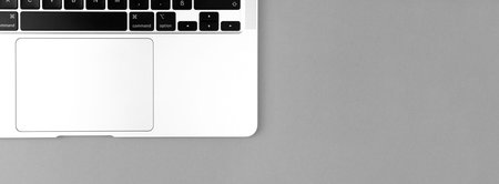 Laptop flat lay silver banner background. Office workspace table, minimal design concept. top view, copy spaceのeditorial素材