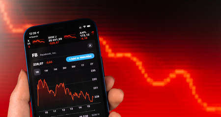 Kharkov, Ukraine - February 11, 2022: Facebook stock trade on red chart. USA company, technology industry. finance market backgroundのeditorial素材