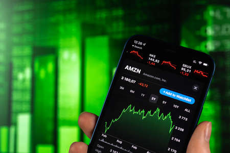 Kharkov, Ukraine - February 11, 2022: Amazon stock trade on green chart. USA company, technology industry. finance market backgroundのeditorial素材