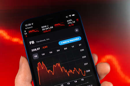 Kharkov, Ukraine - February 11, 2022: Facebook stock trade on red chart. USA company, technology industry. finance market backgroundのeditorial素材