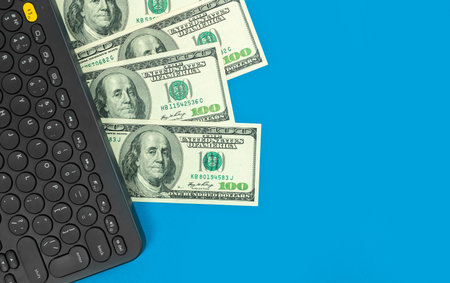 Wireless keyboard with dollar bills. Freelance concept, concept of work at home, making money,...