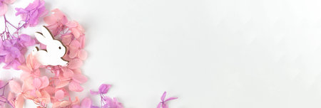 Easter spring flowers and rabbit, banner design. Holiday decoration background with copy space, flat...