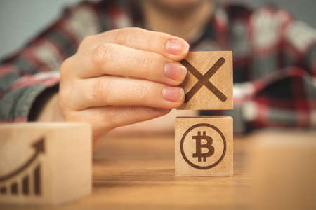 Bitcoin banned concept. Cryptocurrency virtual money cyber security background. Wooden cubes with symbolsの写真素材