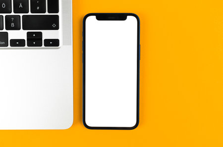 Office desk with Apple iPhone mockup screen. Business flat lay and minimal design background. Top view and copy space photoのeditorial素材