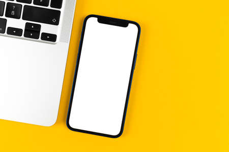 Office desk with Apple iPhone mockup screen. Business flat lay and minimal design background. Top view and copy space photoのeditorial素材