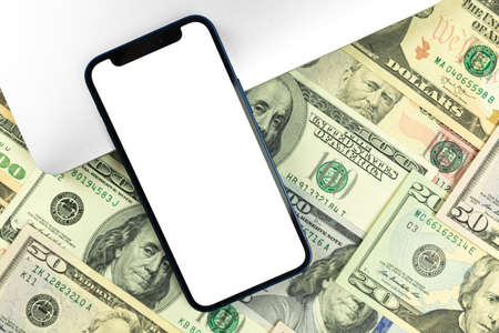 Flat lay Apple iPhone mockup, business office desktop with money and dollar bills background. Top view, copy space photoのeditorial素材