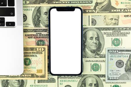 Flat lay Apple iPhone mockup, business office desktop with laptop, money and dollar bills background. Top view, copy space photoのeditorial素材