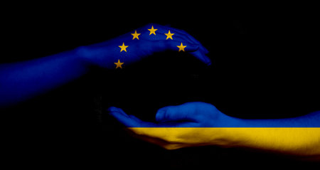 Europe union and Ukraine flags and hands on black background, peace and NATO concept photo