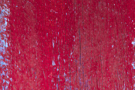 Red wood background. Old weathered wooden plank painted in red. vintage texture closeupの写真素材