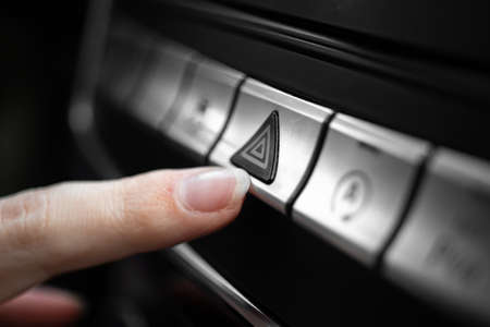 Car emergency light button, triangle car warning button in luxury sport car close-up viewの写真素材