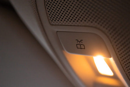 Closeup of cabin lights switch in car, light control panel inside a car interior. For reading etc.