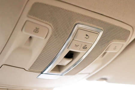 Closeup of cabin lights switch in car, light control panel inside a car interior. For reading etc.の写真素材