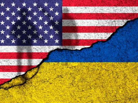 USA support for Ukraine in war. Russian invasion concept. Soldier silhouette. United States of America and Ukraine flags on concrete wall backgroundの写真素材