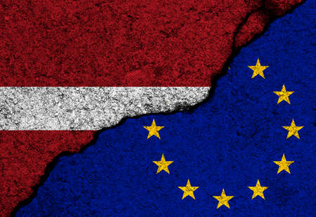 Latvia and Europe Union flags painted on concrete wall backgroundの写真素材