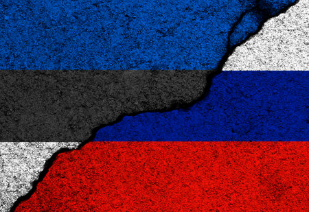 Estonia and Russia flags painted on cracked concrete walls backgroundの写真素材