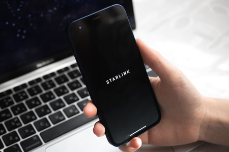 Poltava, Ukraine - March 26, 2022: Starlink application with logo closeup. mobile phone in handのeditorial素材