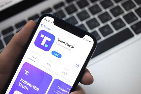 Poltava, Ukraine - March 23, 2022: Truth Social app and logo, social media by Donald Trump, president of the USA. Twitter competitor. Mobile phone with the Truth Socialのeditorial素材