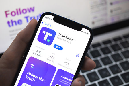 Poltava, Ukraine - March 23, 2022: Truth Social app and logo, social media by Donald Trump, president of the USA. Twitter competitor. Mobile phone with the Truth Socialのeditorial素材