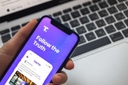Poltava, Ukraine - March 23, 2022: Truth Social app and logo, social media by Donald Trump, president of the USA. Twitter competitor. Mobile phone with the Truth Socialのeditorial素材