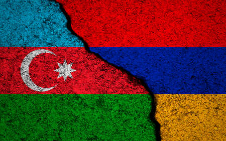 Azerbaijan and Armenia flags background. cracked wall. Military conflict and war conceptの写真素材