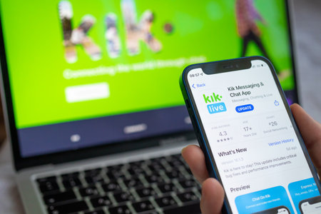 Poltava, Ukraine - March 22, 2022: Kik Messaging app on the mobile phone screen. Woman using Kik social application, icon close-up view photoのeditorial素材