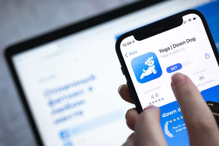 Poltava, Ukraine - April 5, 2022: Yoga Down Dog mobile app on mobile phone screen, close-upのeditorial素材