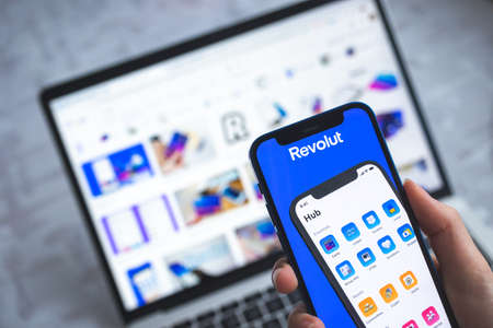 Woman use Revolut app. Mobile phone banking and investment concept photoのeditorial素材