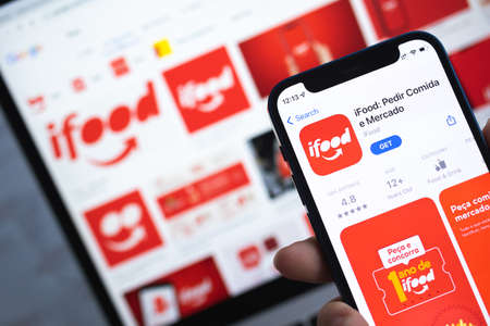 iFood app icon. Hand with mobile phone with application. Food delivery concept photoのeditorial素材