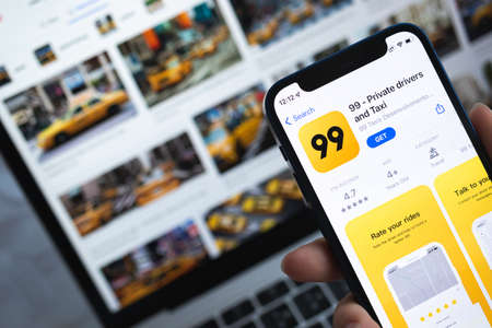 99 taxi app on smartphone screen. Application icon close-up viewのeditorial素材